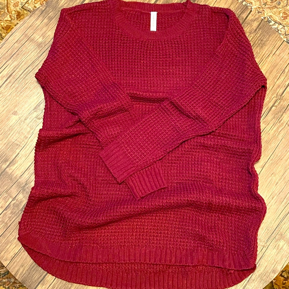 Burgundy pull on crew neck sweater. Banded cuffs and banded along bottom hem